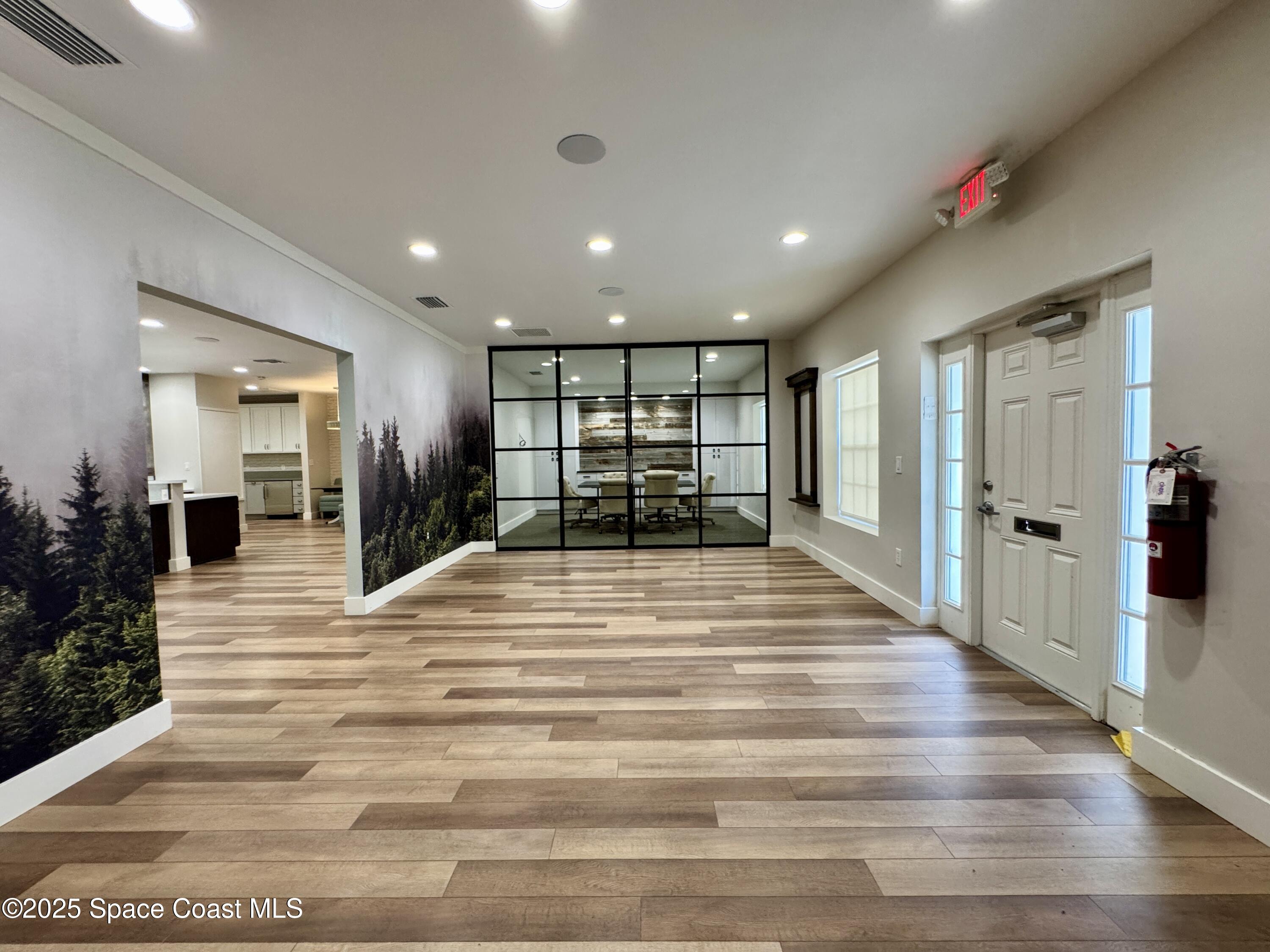 3210 North Wickham Road, Unit 2 Melbourne, FL 32935 - Photo 2 of 14 a view of a hallway with wooden floor and a bathroom