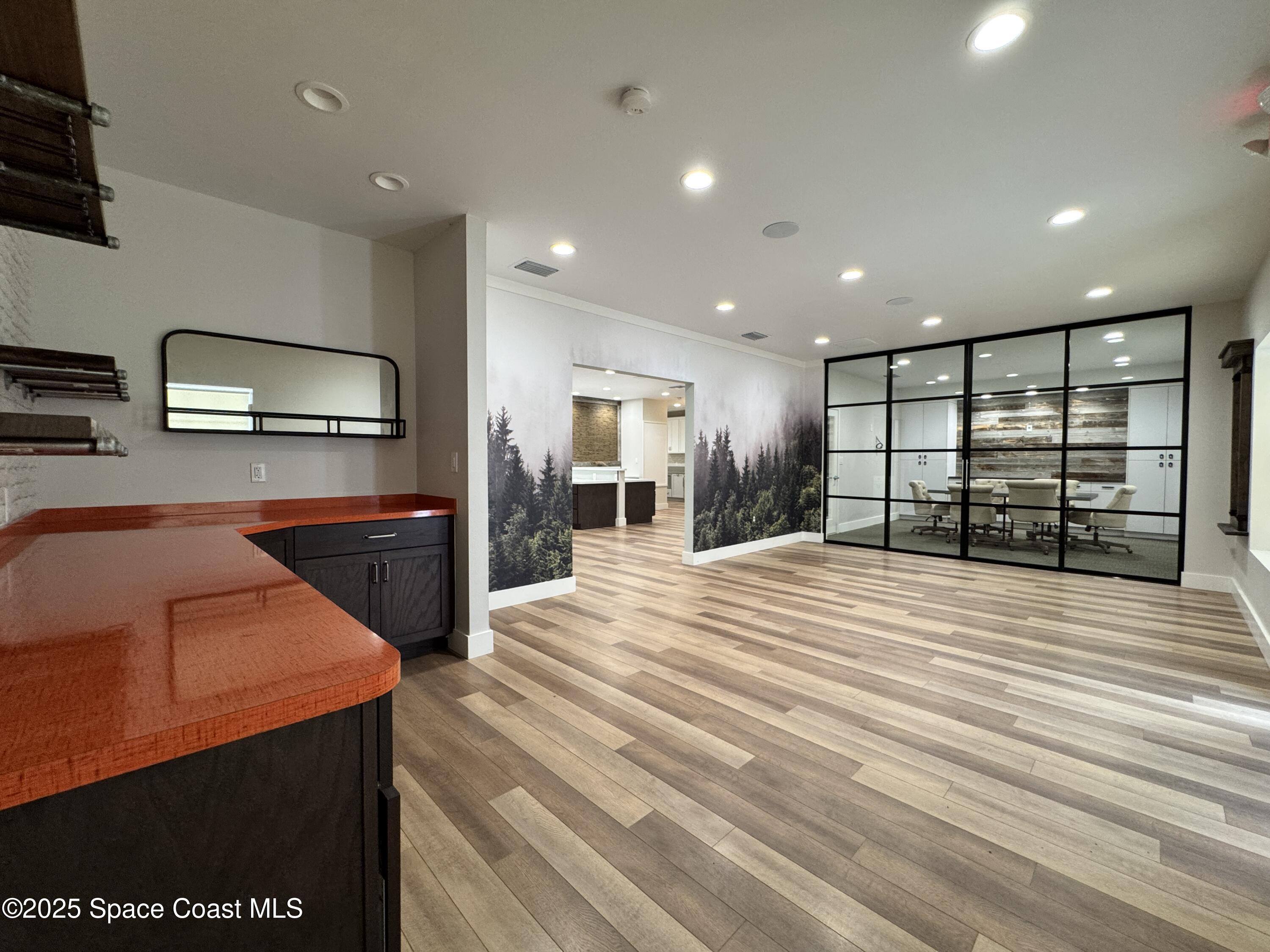 3210 North Wickham Road, Unit 2 Melbourne, FL 32935 - Photo 4 of 14 a large kitchen with stainless steel appliances kitchen island a large counter top