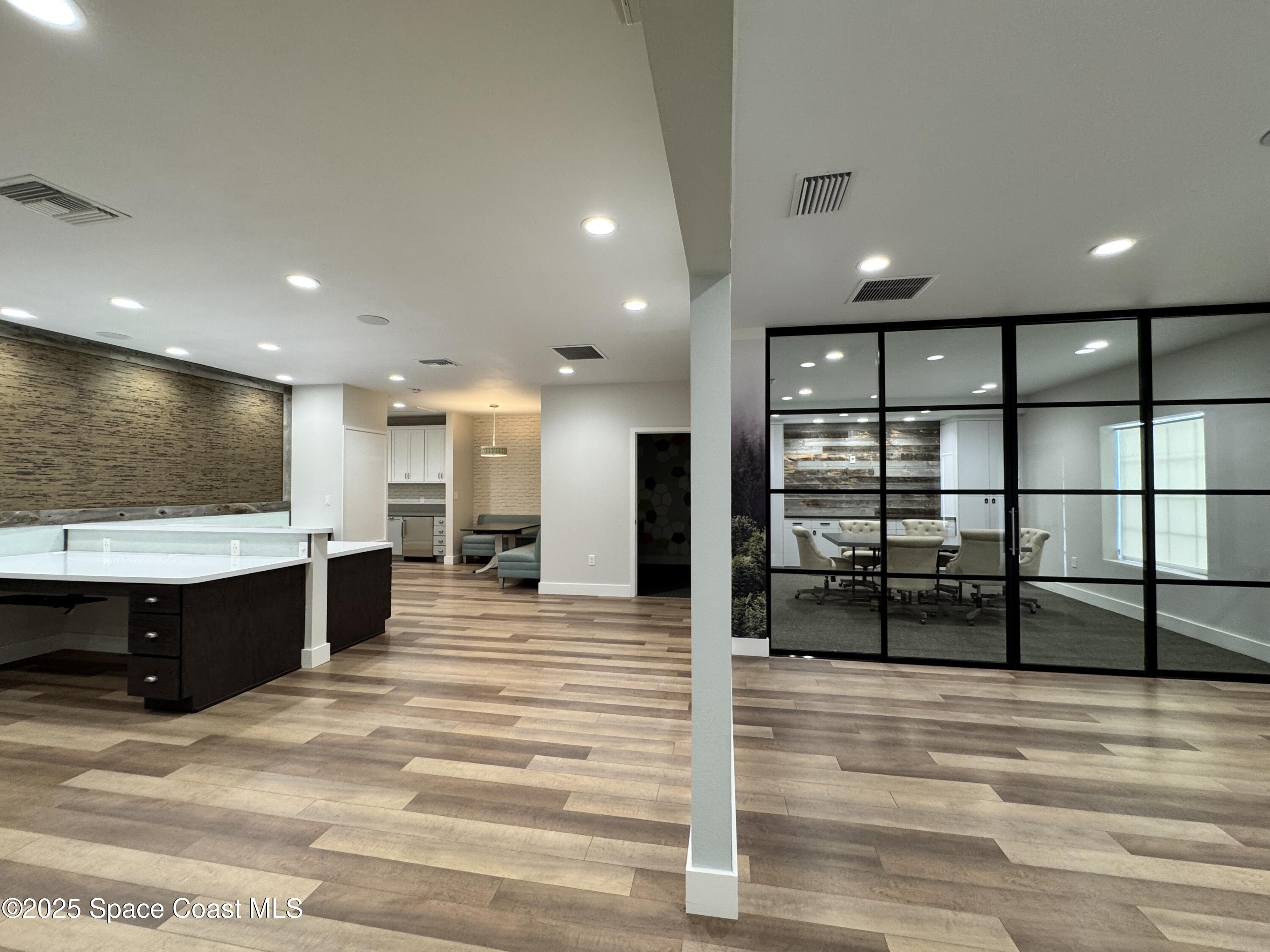 3210 North Wickham Road, Unit 2 Melbourne, FL 32935 - Photo 5 of 14 a view of a living room a hall and kitchen view