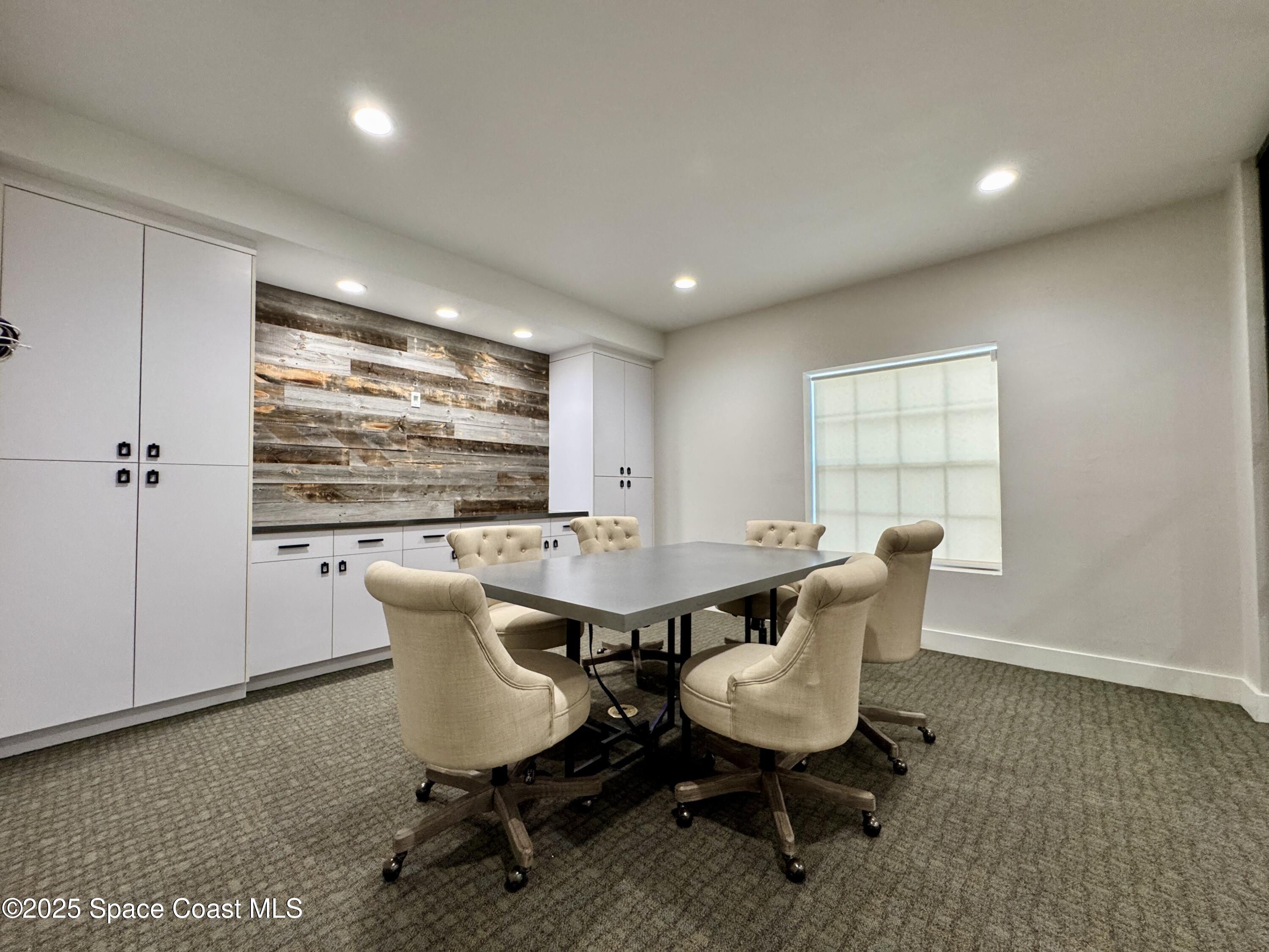 3210 North Wickham Road, Unit 2 Melbourne, FL 32935 - Photo 8 of 14 a dining room with furniture and window