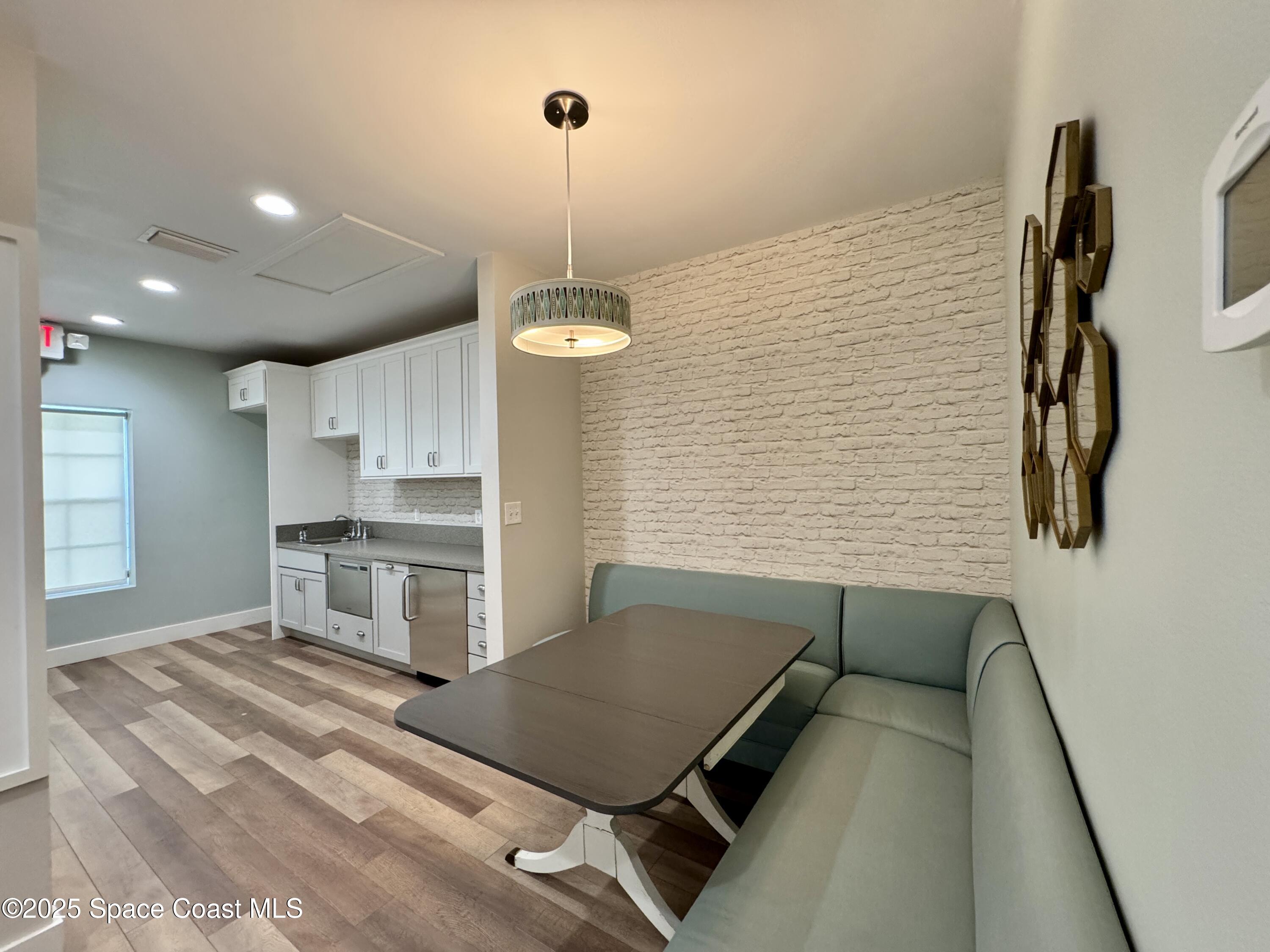 3210 North Wickham Road, Unit 2 Melbourne, FL 32935 - Photo 9 of 14 a kitchen with stainless steel appliances kitchen island a stove and a refrigerator