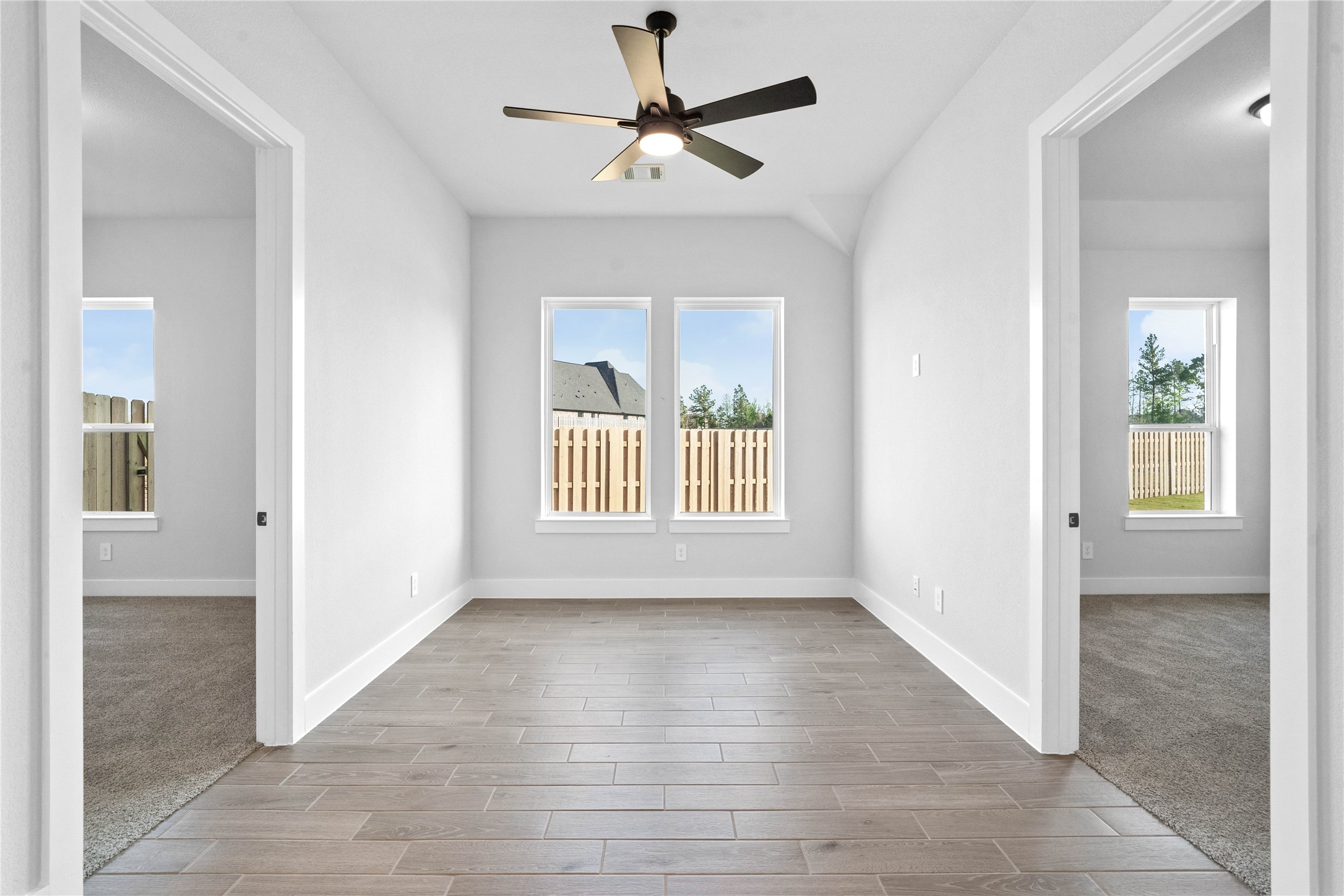 2114 Rowl Street Montgomery, TX 77316 - Photo 12 of 50 Perfectly positioned between two secondary bedrooms, this expansive living area offers ultimate flexibility for a modern lifestyle. Whether you envision a state-of-the-art media room, a dedicated teen hangout, an active game room, or a quiet collaborative study area, this strategically placed space adapts to your needs.