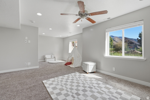 1997 East 600 South Springville, UT 84663 - Photo 45 of 54 Recessed ceiling lighting, ceiling fan with wood-finish blades, light gray carpeting, and a bright window with white trim
