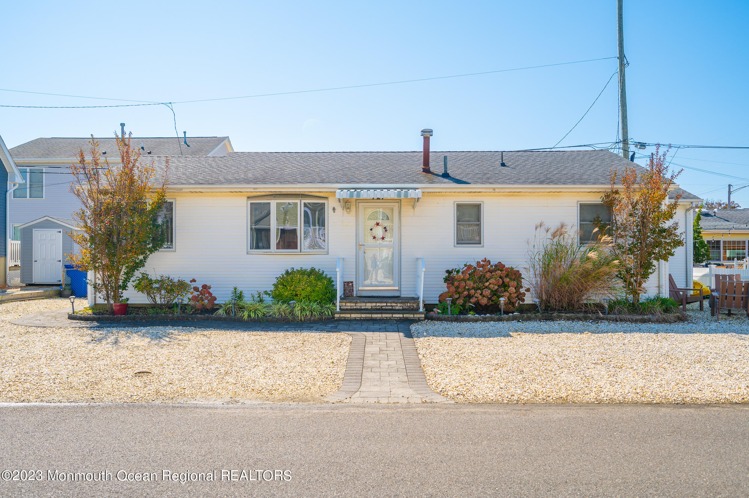 121 Jacobsen Lane Lavallette, NJ 08735 - Photo 1 of 19 a front view of a house with garden