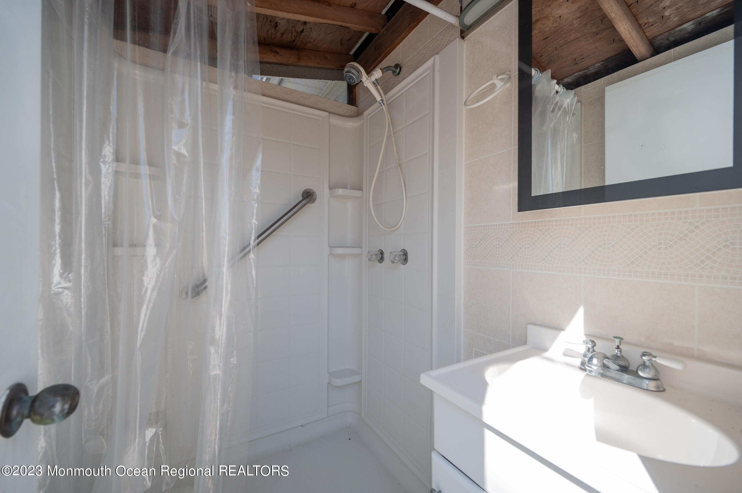 121 Jacobsen Lane Lavallette, NJ 08735 - Photo 13 of 19 a bathroom with a sink and shower