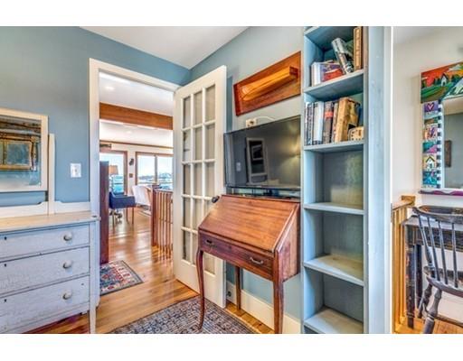 2 Gas House Lane Marblehead, MA 01945 - Photo 13 of 25 a living room with furniture a fireplace and a flat screen tv