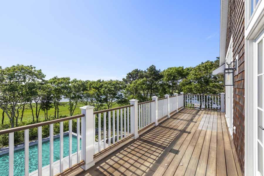160 Peppercorn Lane Cotuit, MA 02635 - Photo 27 of 43 a balcony with wooden floor and fence