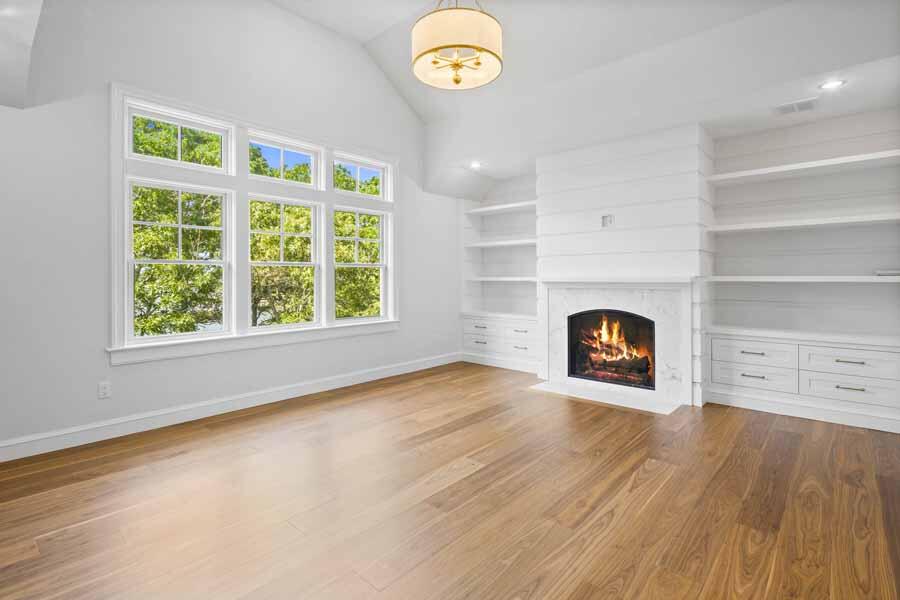 160 Peppercorn Lane Cotuit, MA 02635 - Photo 30 of 43 an empty room with windows and fireplace