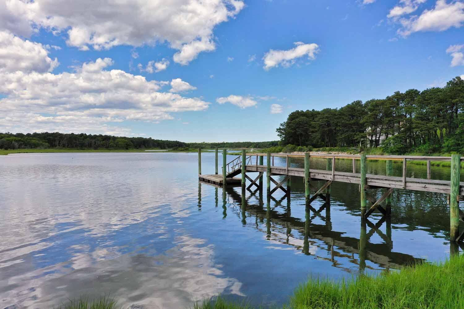 160 Peppercorn Lane Cotuit, MA 02635 - Photo 42 of 43 a view of a lake with a table and chairs