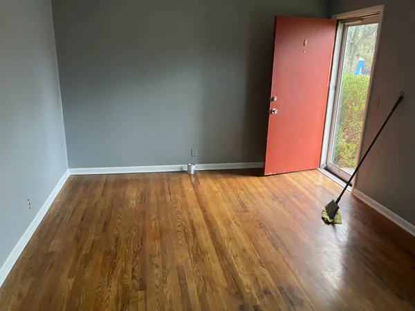 a view of a room with wooden floor