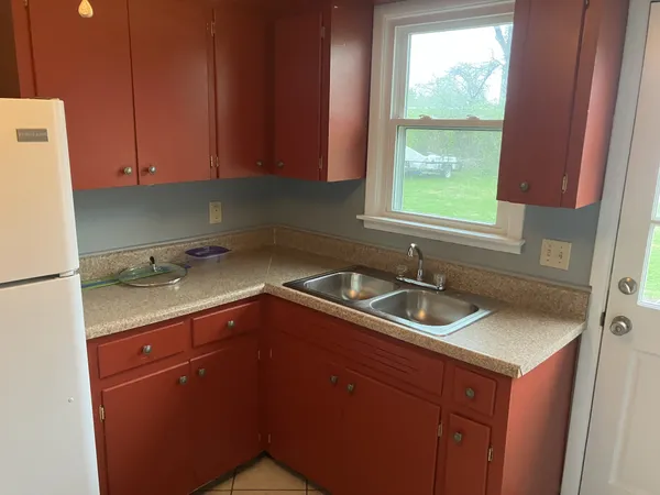 a kitchen with a sink cabinets and window