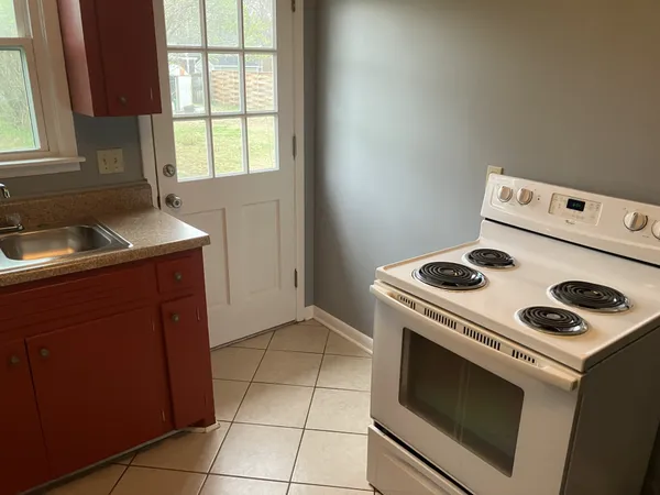 a kitchen with a stove cabinets and sink