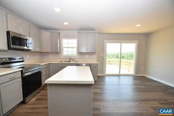 a kitchen with counter top space cabinets and appliances