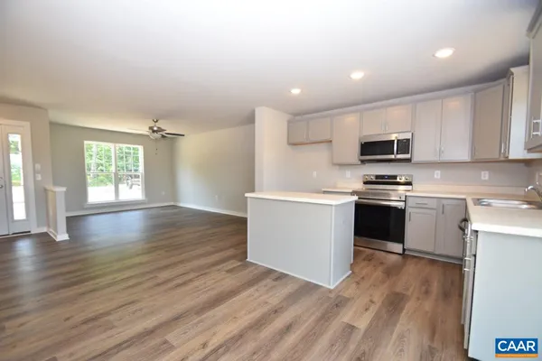 a kitchen with wooden floors and white appliances