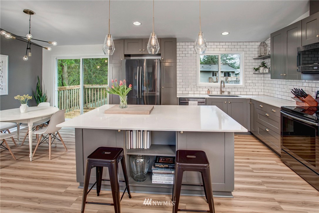 2321 177th Street Southeast Bothell, WA 98012 - Photo 13 of 28 a kitchen with a table chairs refrigerator and microwave