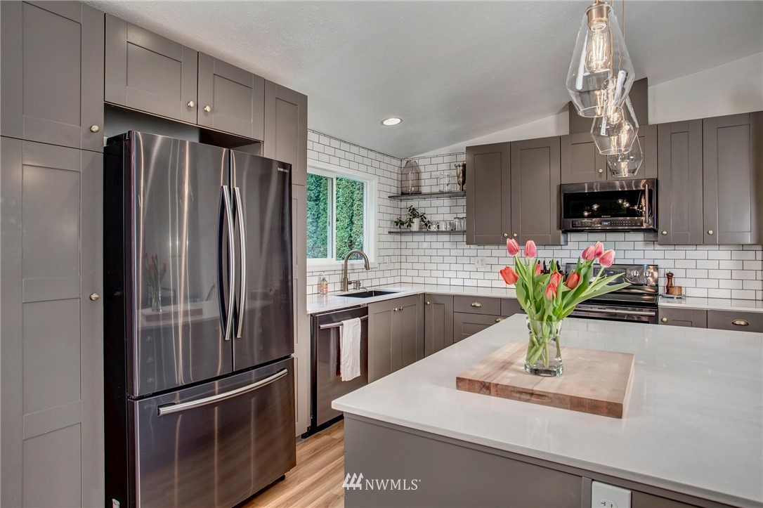 2321 177th Street Southeast Bothell, WA 98012 - Photo 14 of 28 a kitchen with a refrigerator and a white cabinets