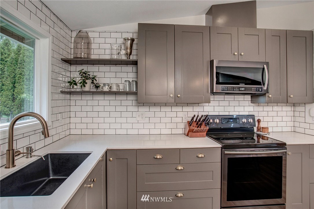 2321 177th Street Southeast Bothell, WA 98012 - Photo 15 of 28 a kitchen with a sink stove and cabinets