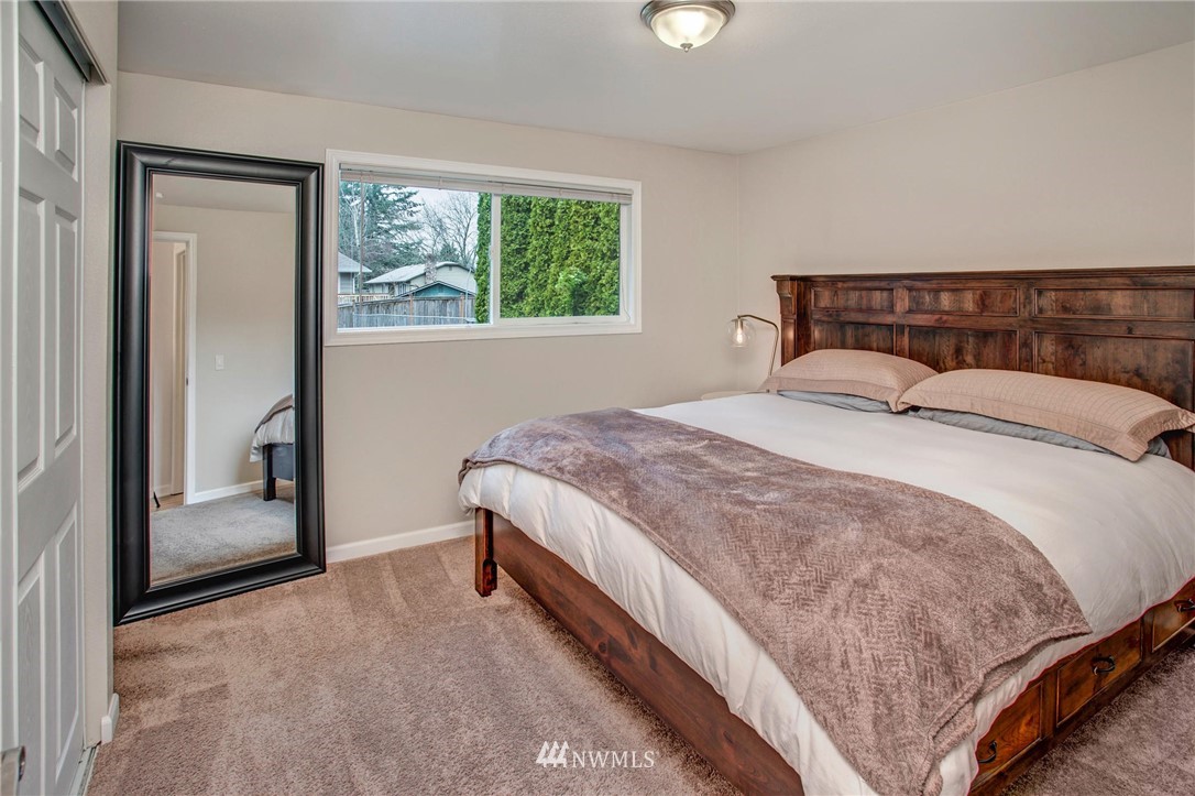 2321 177th Street Southeast Bothell, WA 98012 - Photo 17 of 28 a bedroom with a bed lamp and window
