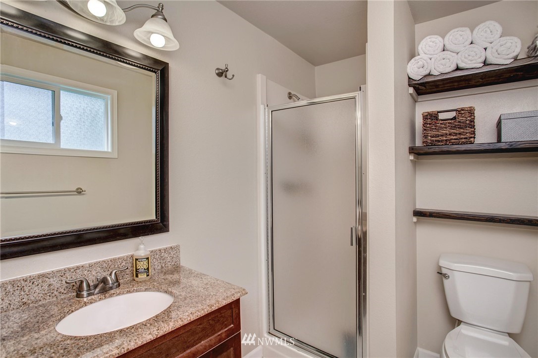 2321 177th Street Southeast Bothell, WA 98012 - Photo 19 of 28 a bathroom with a granite countertop sink toilet and shower