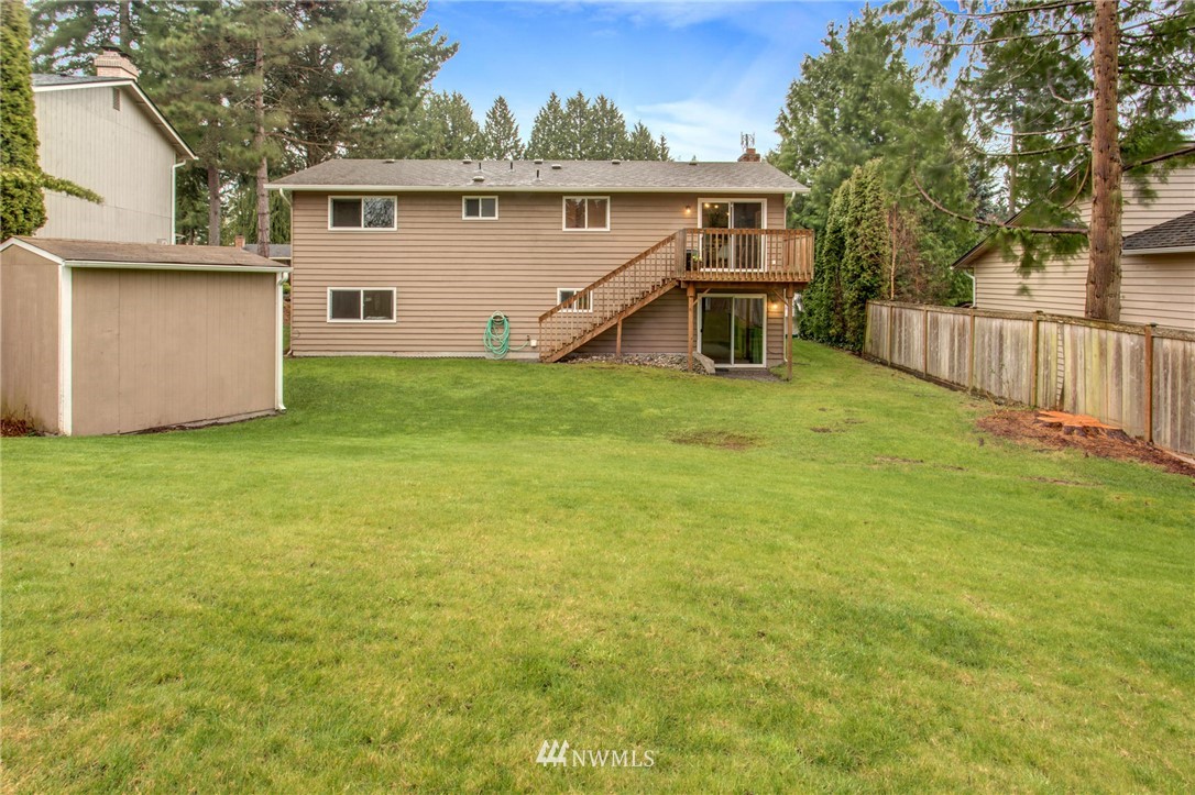 2321 177th Street Southeast Bothell, WA 98012 - Photo 26 of 28 a view of a backyard with wooden fence and a small cabin