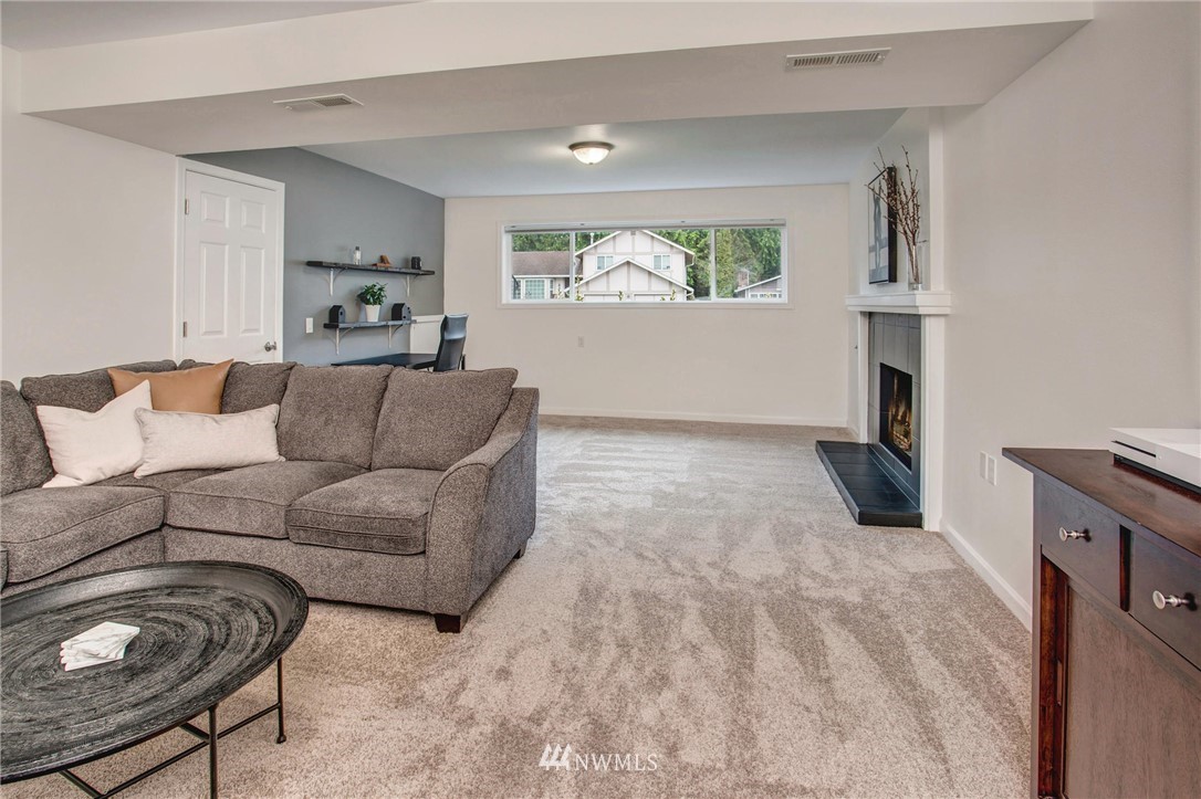 2321 177th Street Southeast Bothell, WA 98012 - Photo 27 of 28 a living room with furniture and a fireplace