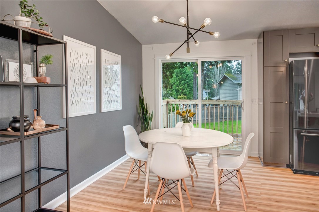 2321 177th Street Southeast Bothell, WA 98012 - Photo 6 of 28 a view of a dining room with furniture window and wooden floor