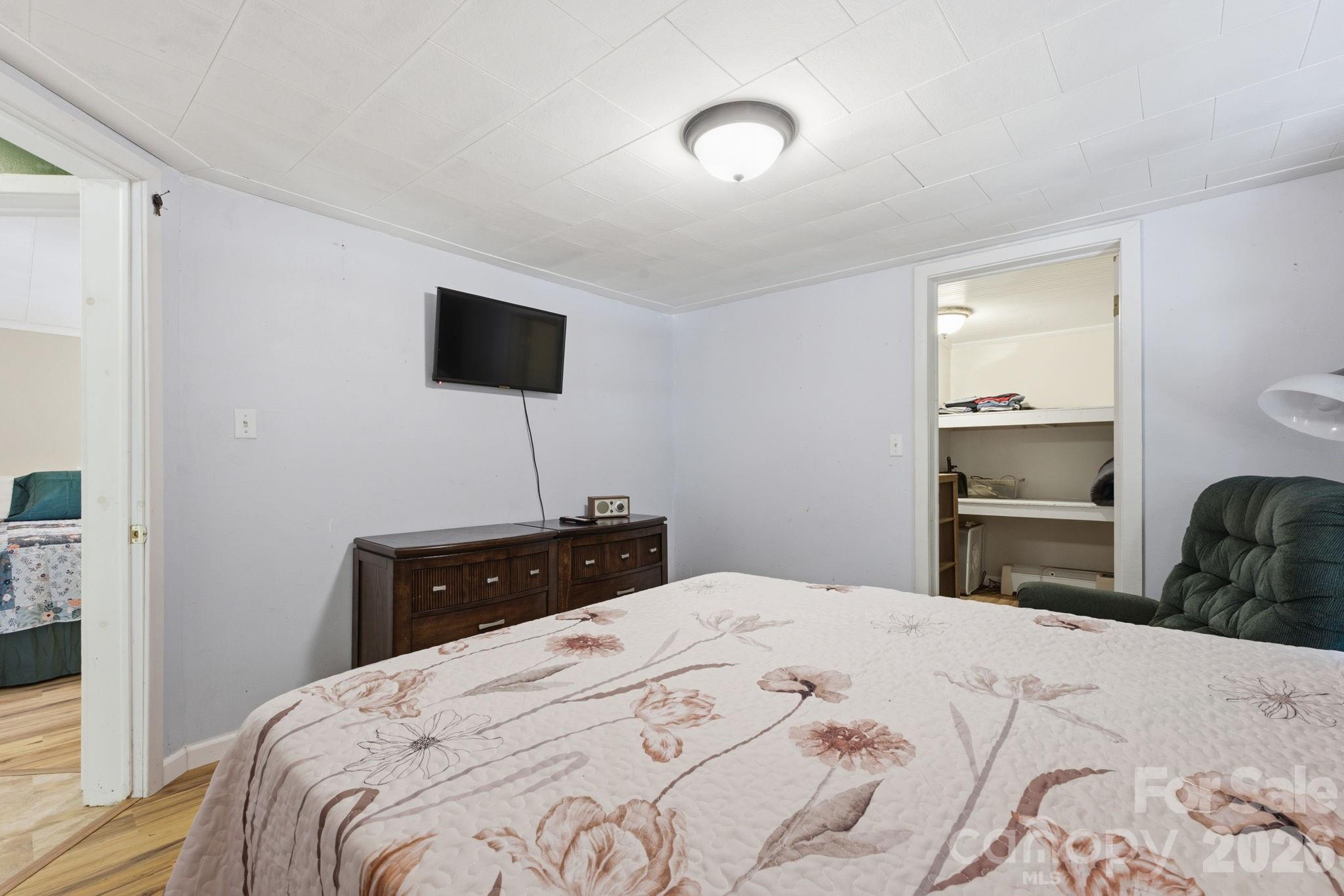 583 Dark Ridge Road Sylva, NC 28779 - Photo 31 of 48 a bedroom with a bed and a flat screen tv