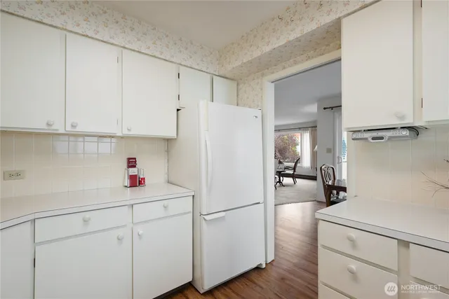 a white refrigerator freezer sitting inside of a kitchen