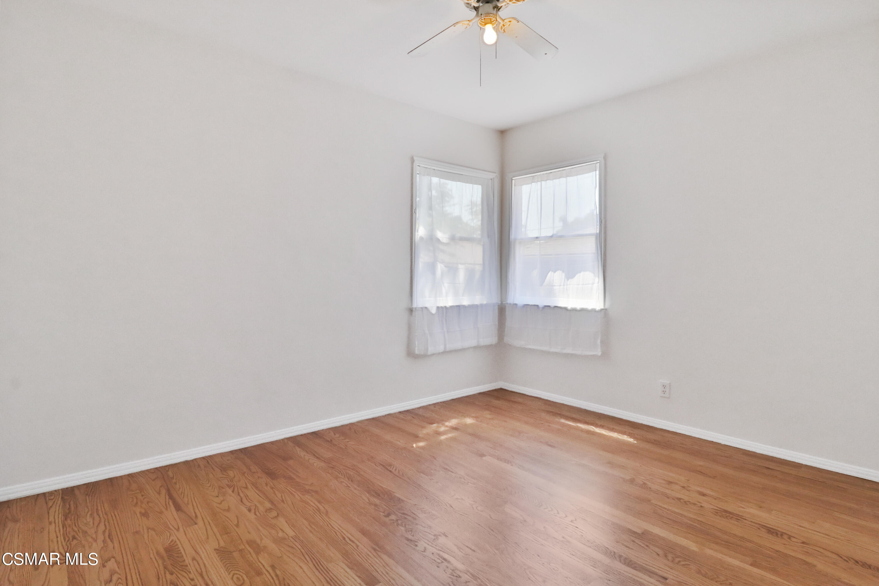 10010 Silverton Avenue Tujunga, CA 91042 - Photo 15 of 30 an empty room with wooden floor and windows
