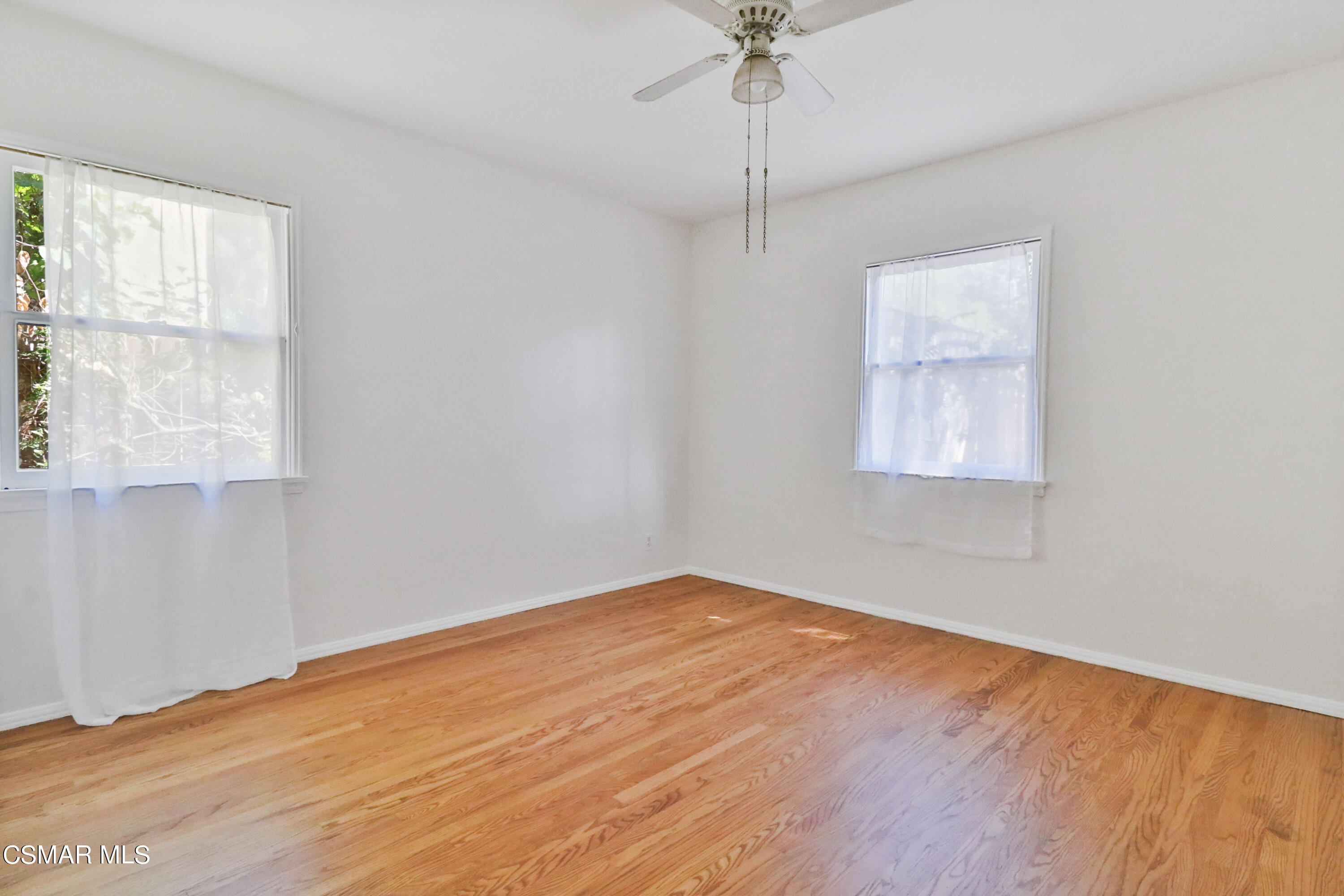 10010 Silverton Avenue Tujunga, CA 91042 - Photo 16 of 30 wooden floor in an empty room with a window