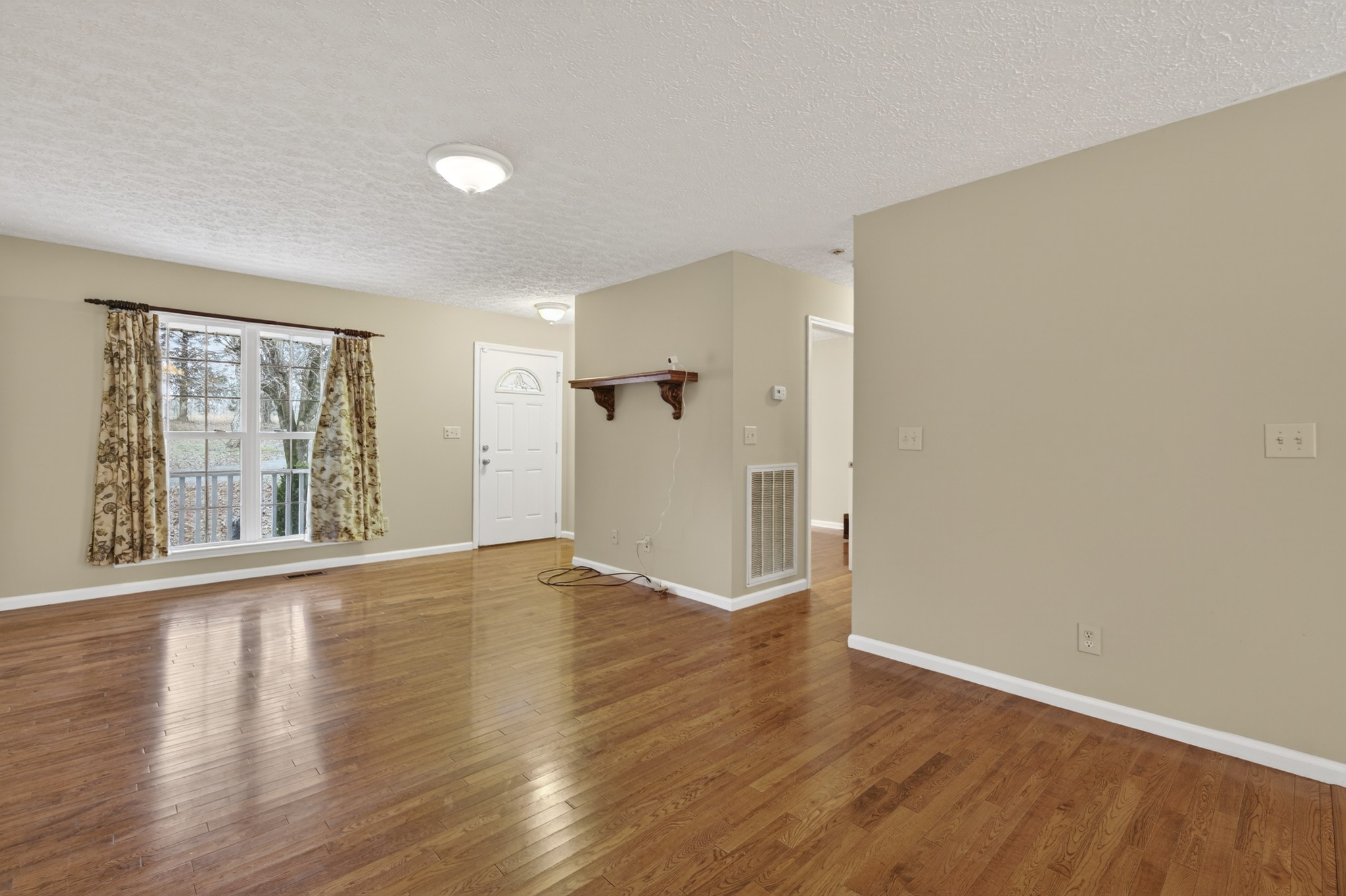 1041 Timber Ridge Road Charlotte, TN 37036 - Photo 11 of 20 a view of an empty room with wooden floor and a window