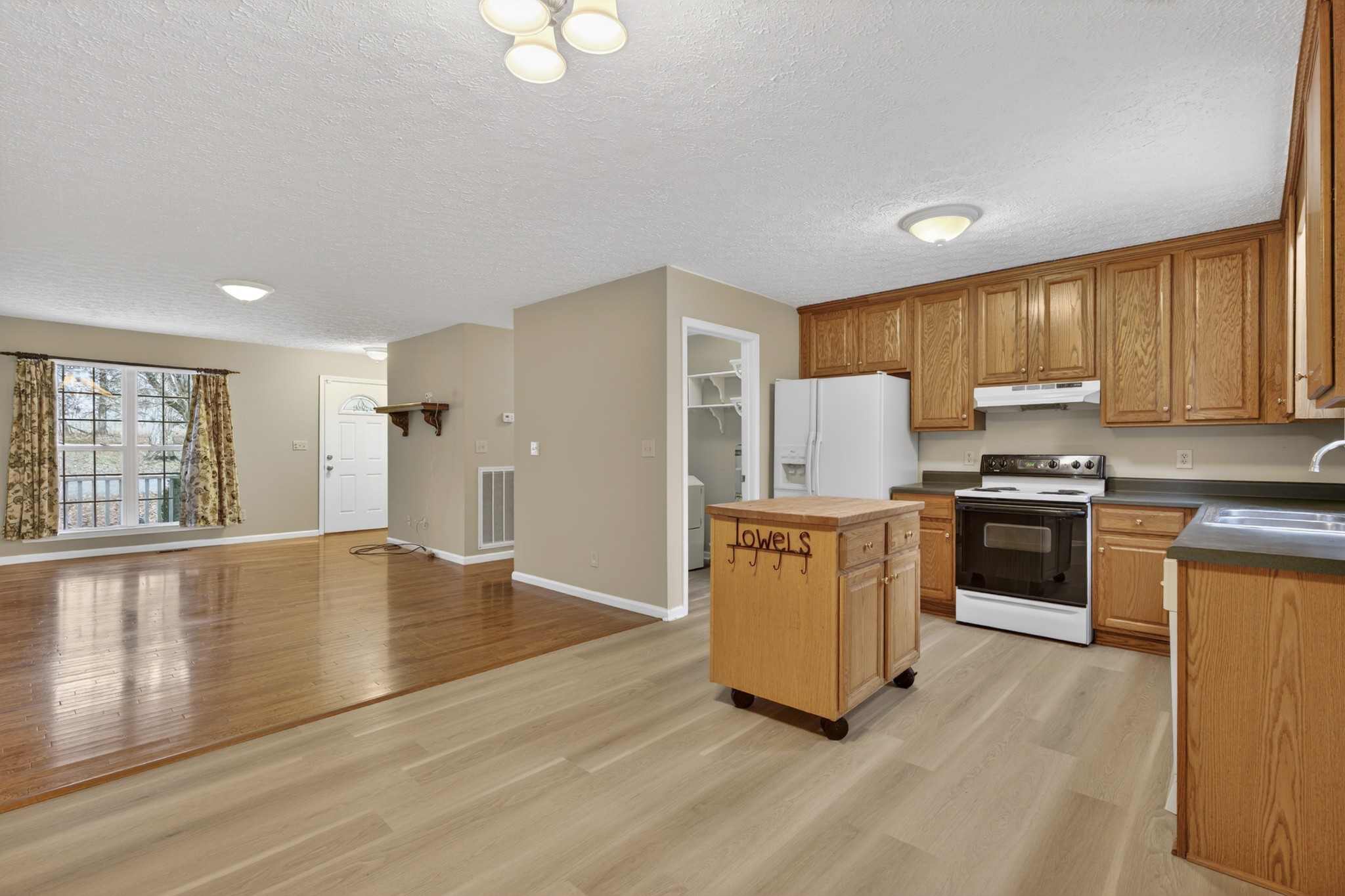 1041 Timber Ridge Road Charlotte, TN 37036 - Photo 13 of 20 a kitchen with granite countertop a stove top oven a sink dishwasher and a refrigerator with wooden floor