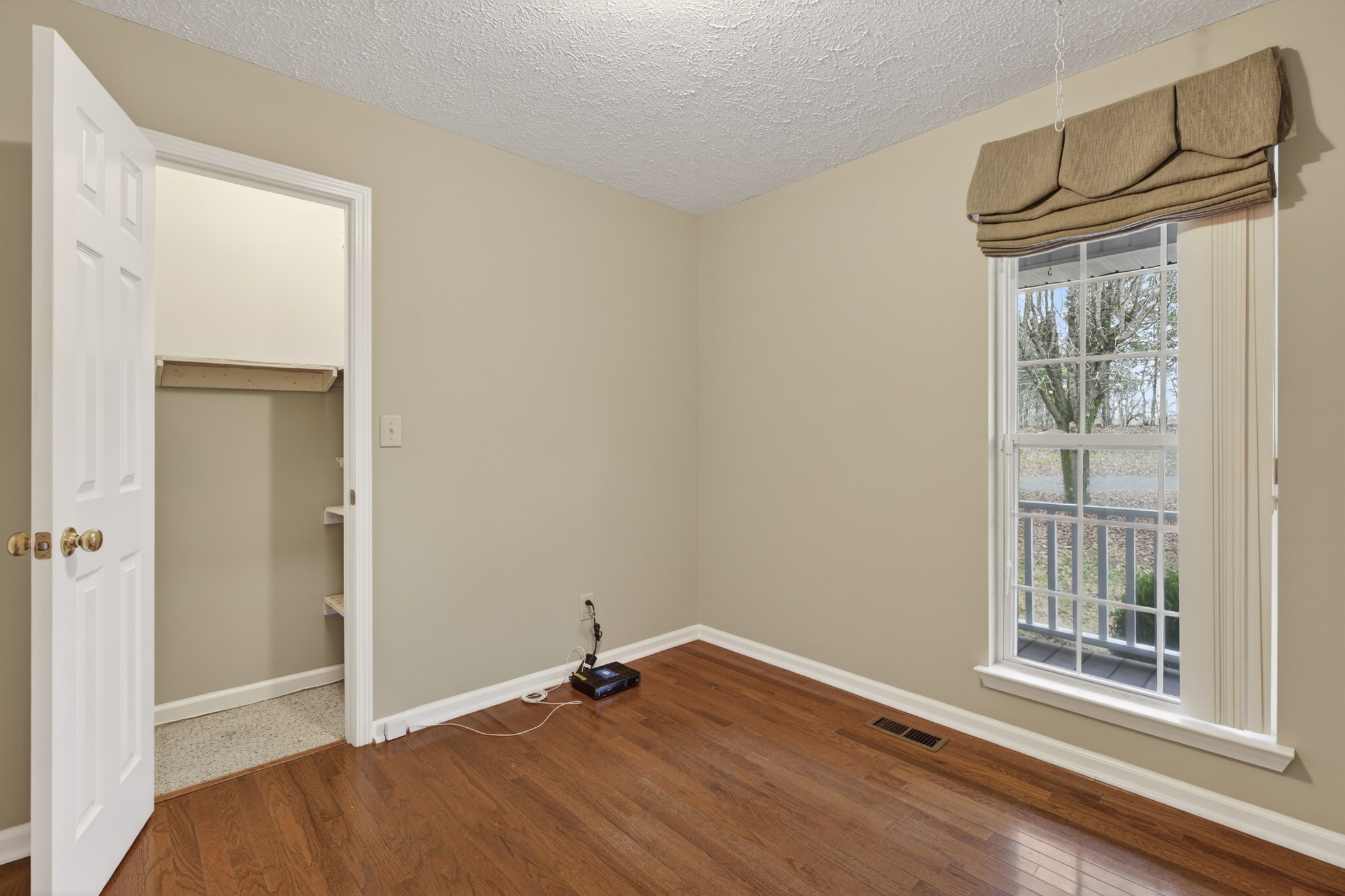 1041 Timber Ridge Road Charlotte, TN 37036 - Photo 15 of 20 a view of empty room with wooden floor and fan