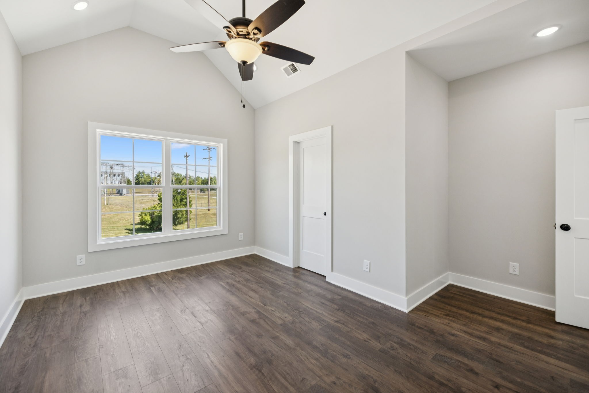 119 East Campbell Road, Unit A Madison, TN 37115 - Photo 17 of 28 an empty room with wooden floor chandelier fan and windows