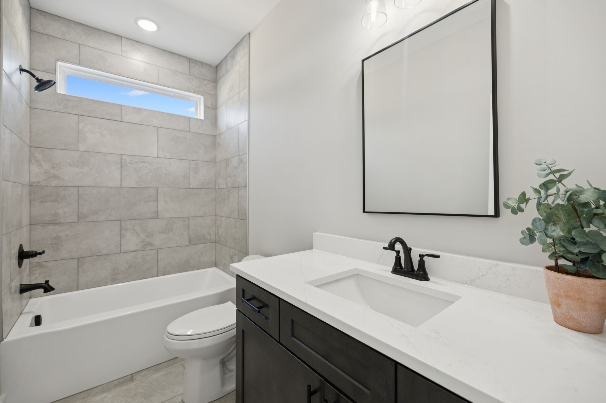 119 East Campbell Road, Unit A Madison, TN 37115 - Photo 6 of 28 a bathroom with a sink a toilet a mirror a bathtub and shower