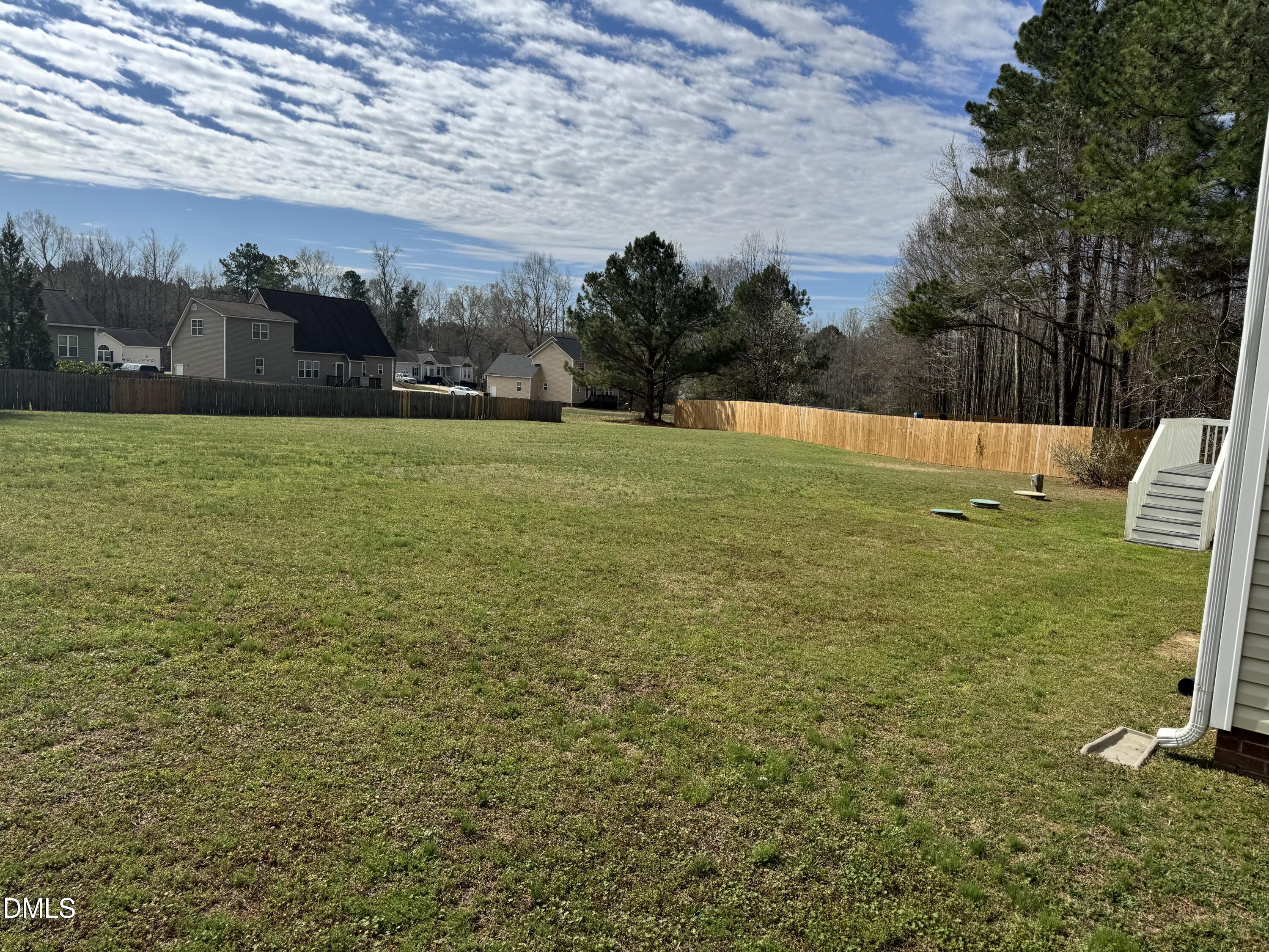 1417 Pleasant Quail Court Raleigh, NC 27603 - Photo 2 of 17 a view of a field with an trees in the background