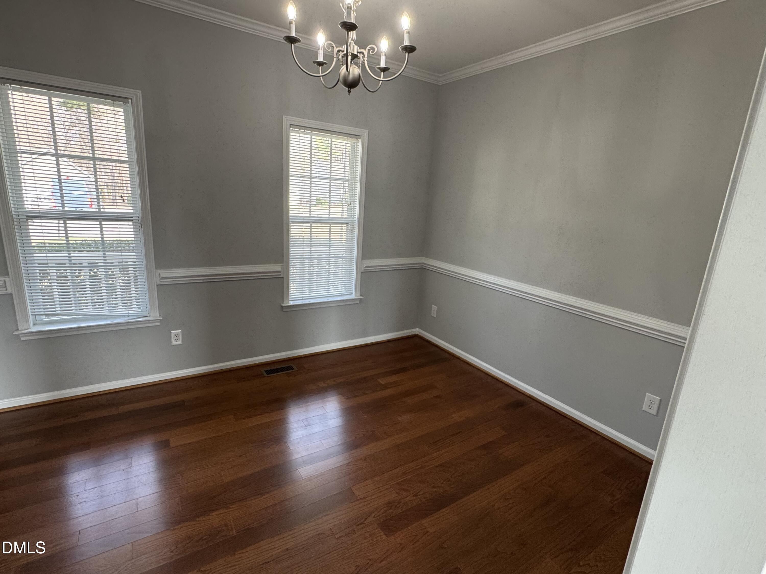1417 Pleasant Quail Court Raleigh, NC 27603 - Photo 4 of 17 a view of an empty room with wooden floor and a window
