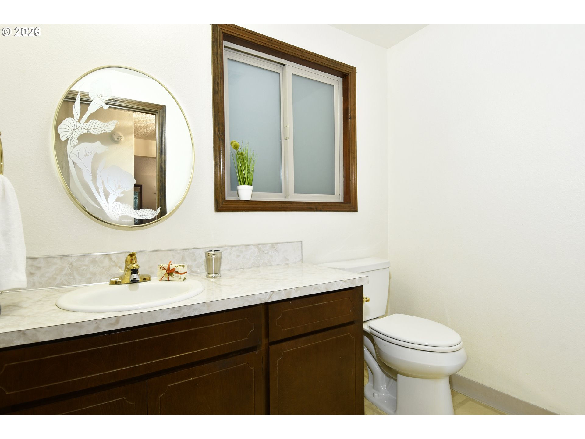 18031 Southeast 370th Avenue Sandy, OR 97055 - Photo 13 of 24 a bathroom with a toilet a sink a vanity and mirror