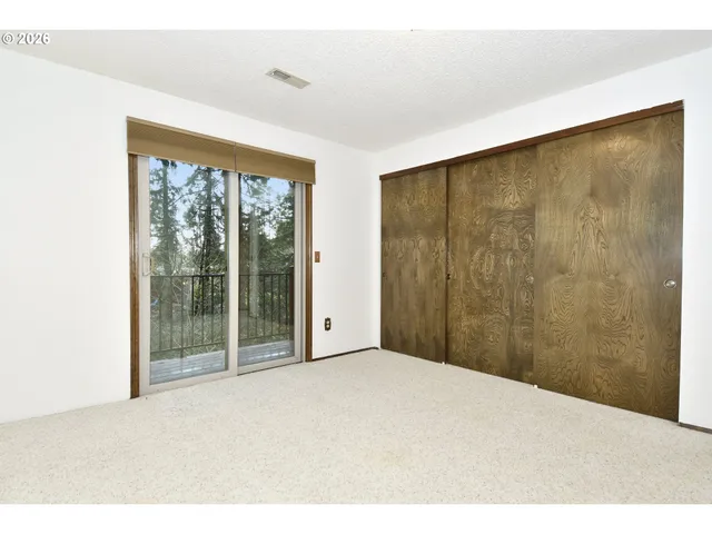 a view of an empty room with glass door
