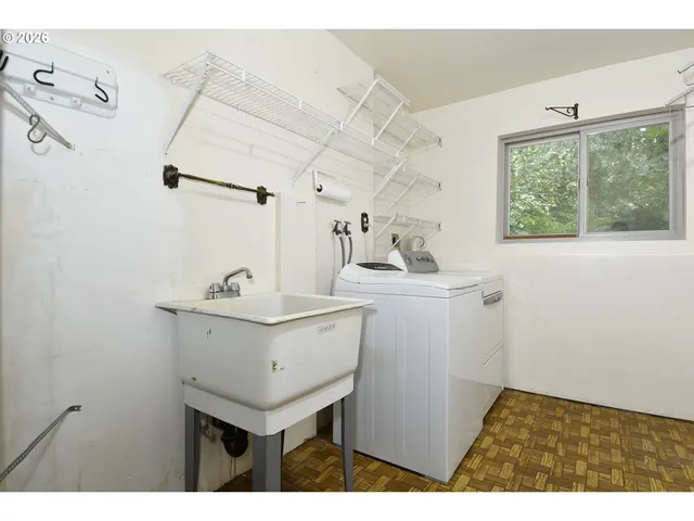 a utility room with sink dryer and washer