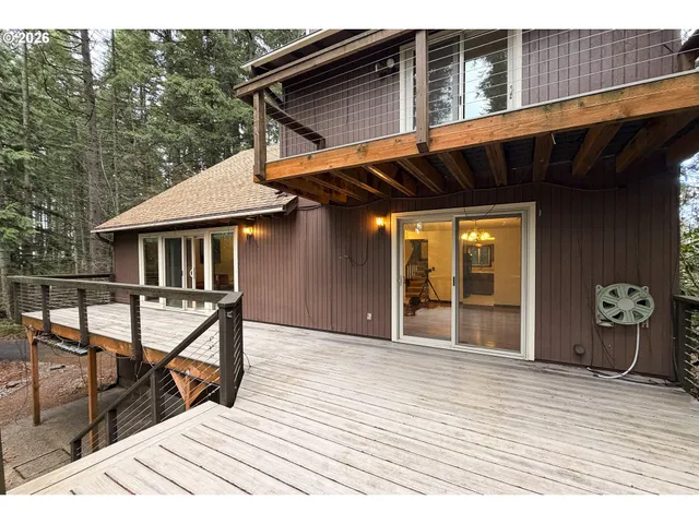 a view of a house with wooden deck