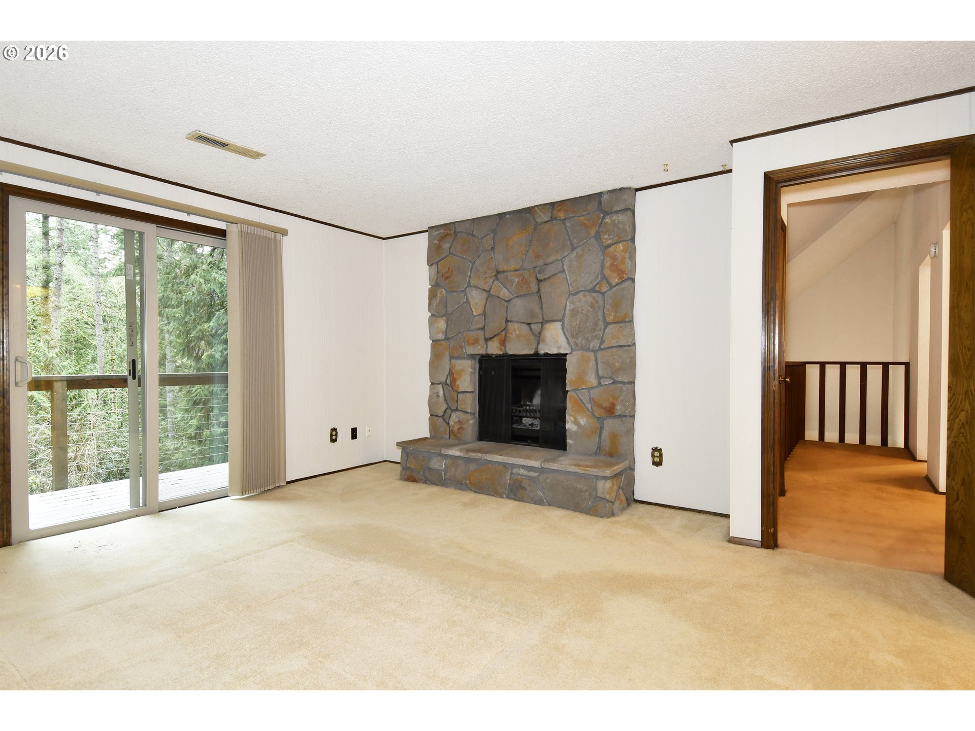 18031 Southeast 370th Avenue Sandy, OR 97055 - Photo 8 of 24 a view of an empty room with a fireplace and a window