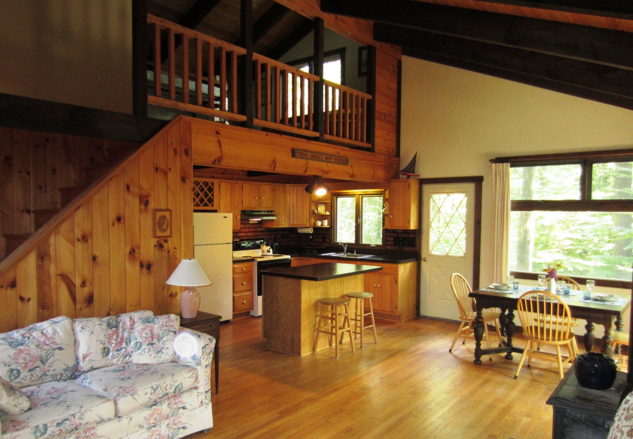 47 Slope Road Tolland, MA 01034 - Photo 19 of 19 a dining room with wooden floor a glass table and chairs
