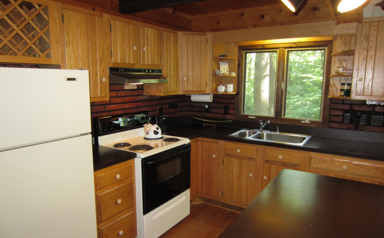 47 Slope Road Tolland, MA 01034 - Photo 10 of 19 a kitchen with a sink stove and cabinets
