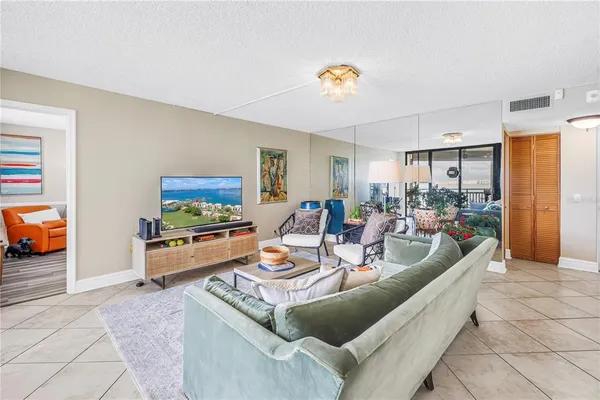 a living room with furniture and a floor to ceiling window
