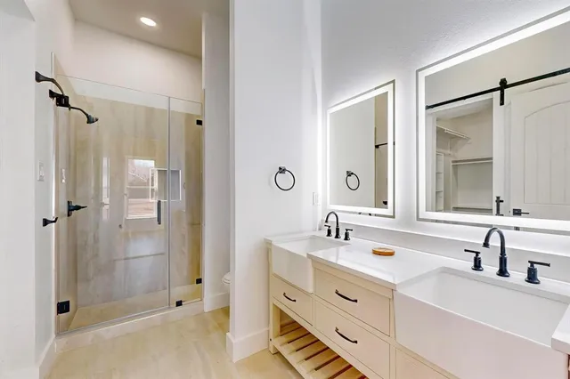 a bathroom with double vanity sink and mirror