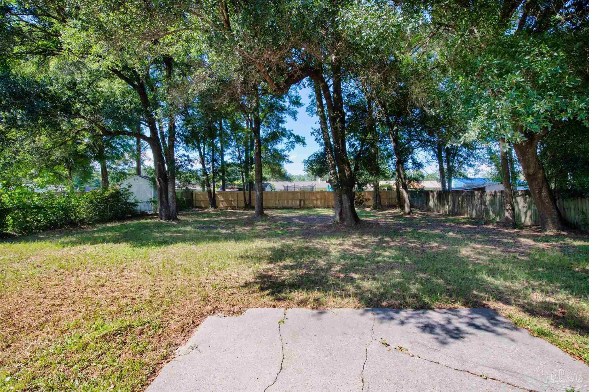 5499 Chantilly Circle Milton, FL 32583 - Photo 23 of 24 a view of outdoor space with trees