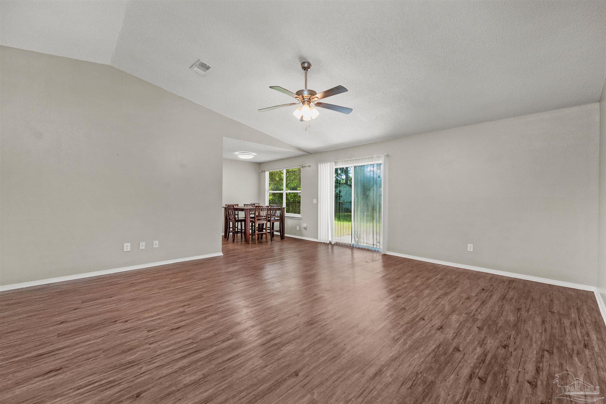 5499 Chantilly Circle Milton, FL 32583 - Photo 5 of 24 wooden floor in an empty room with a window