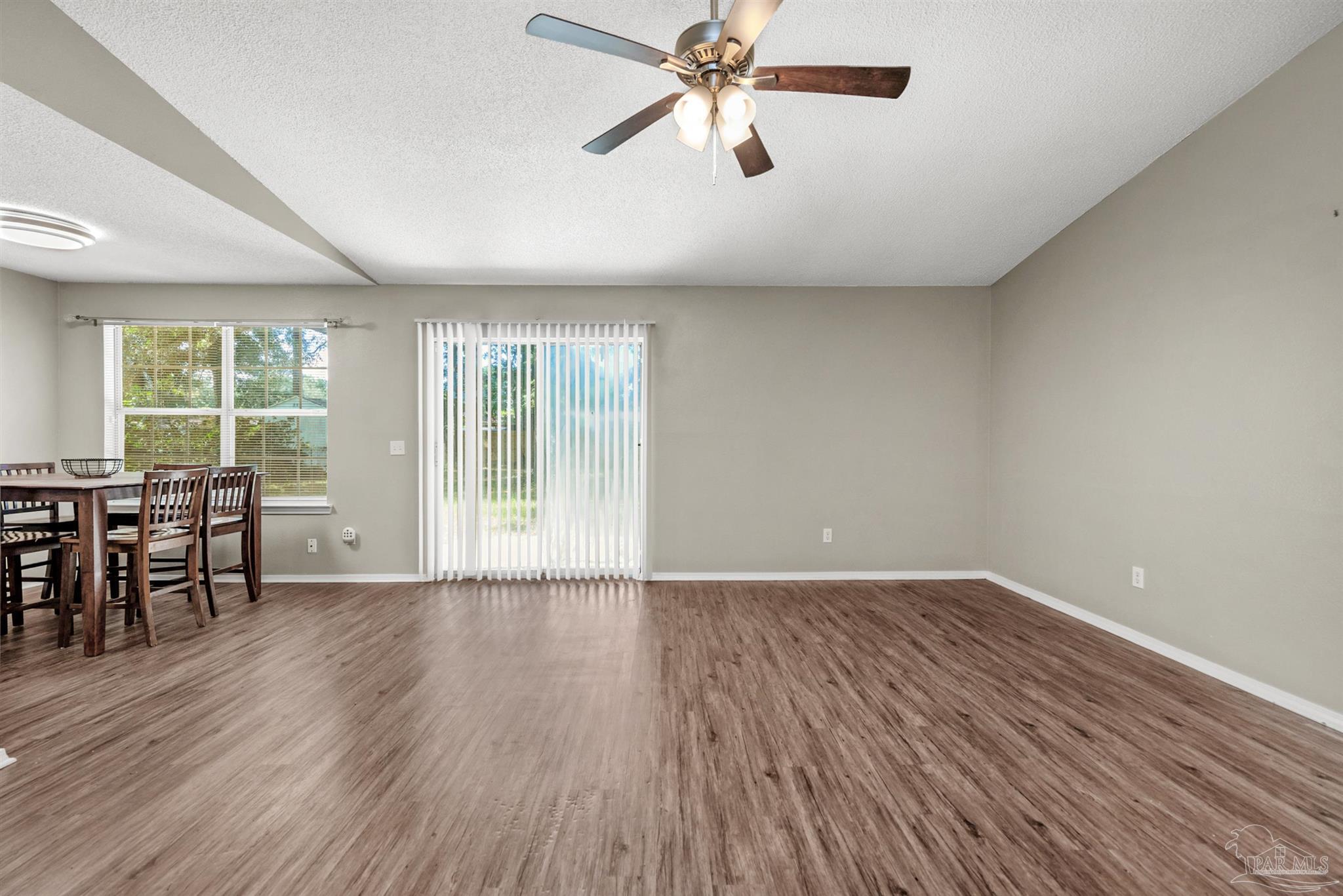 5499 Chantilly Circle Milton, FL 32583 - Photo 6 of 24 an empty room with wooden floor and windows