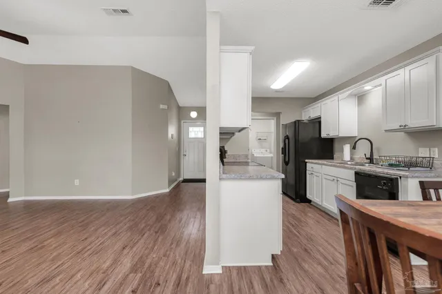 a kitchen with stainless steel appliances a refrigerator sink and cabinets
